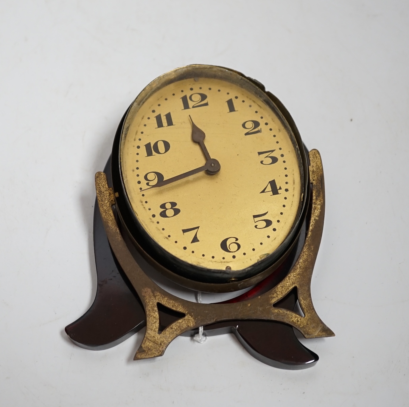 A cherry amber Bakelite framed Art Deco clock (needs assembly)
